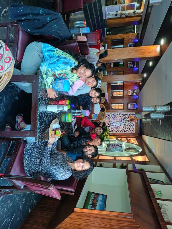 Rang Kaarwaan team members gathered around a table in warm collaboration, showcasing diversity and unity